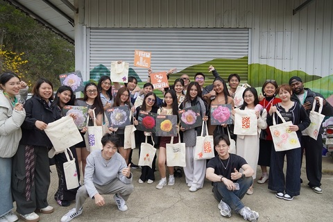 Graduate students from CHU's Tourism Master's Program and an exchange delegation from Lyceum of the Philippines University Laguna Campus (LPU-L) pose happily together after completing their customized silk-screen printed canvas bags at the USR Camellia venue, showcasing the creative results of cross-cultural exchange.Image